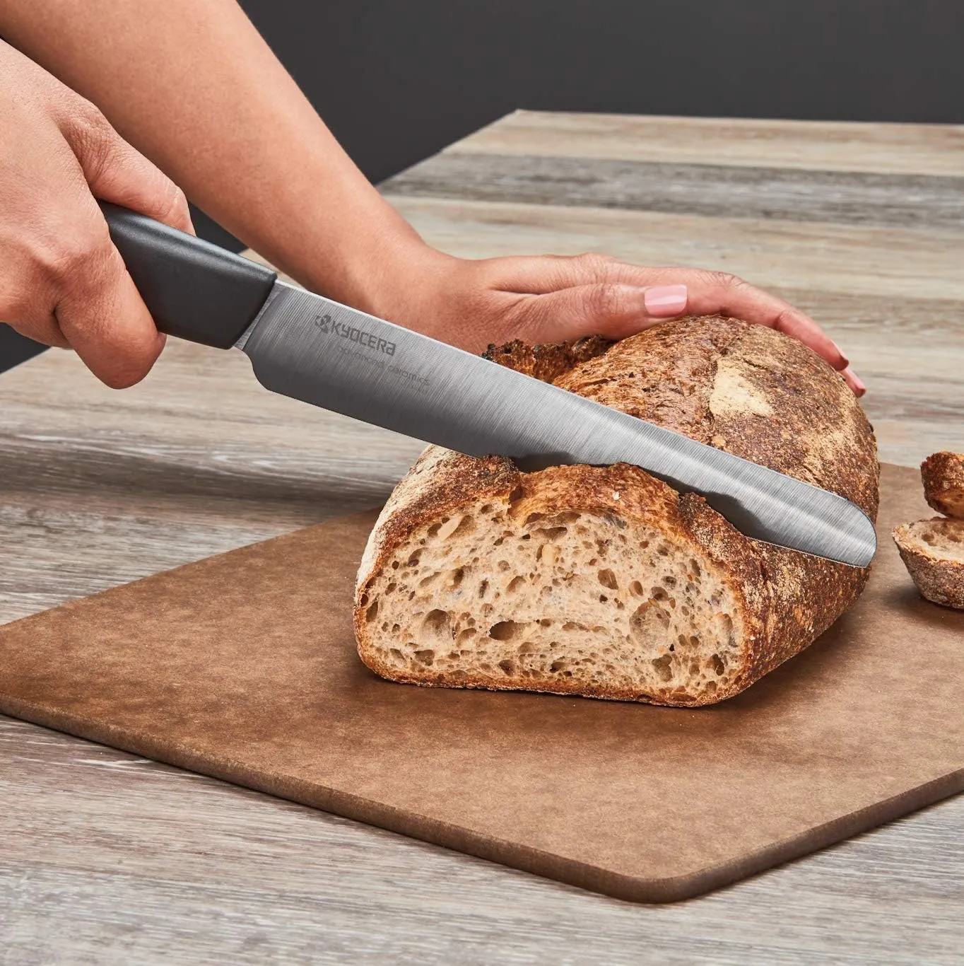 Kyocera Advanced Ceramic Revolution Series 7-inch Serrated Slicing/Bread Knife, Black Handle, Black Blade